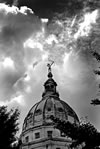 Black and white dome and statue against partly cloudy sky